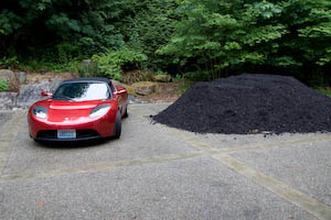 Roadster next to gigantic mulch pile
